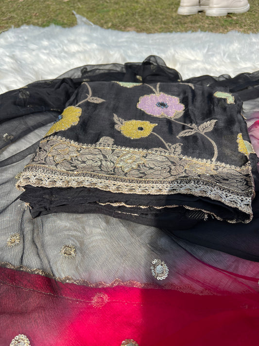 Close-up of fine georgette fabric and detailed weaving in a black Banarasi suit.