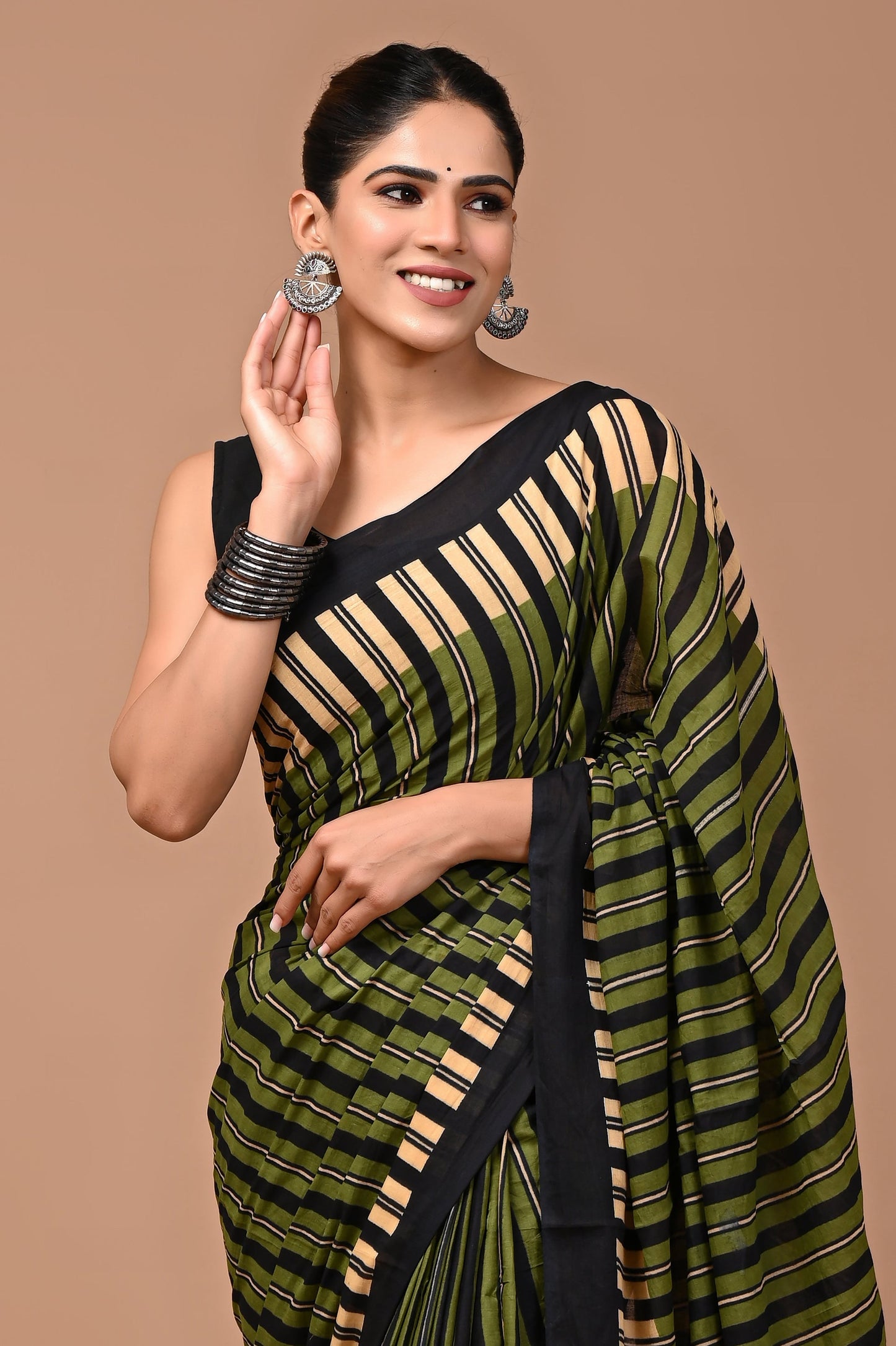 A premium cotton mulmul saree with unique designer prints, includes a matching blouse piece for a chic and effortless style.