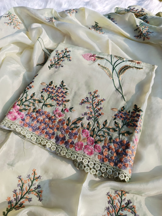 Close-up of delicately embroidered neckline on an organza silk suit highlighting fine craftsmanship