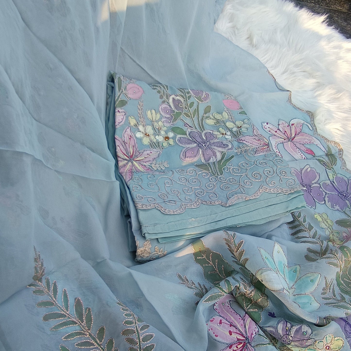 Graceful unstitched fabric with floral embroidery, perfect for creating bespoke traditional or modern outfits.