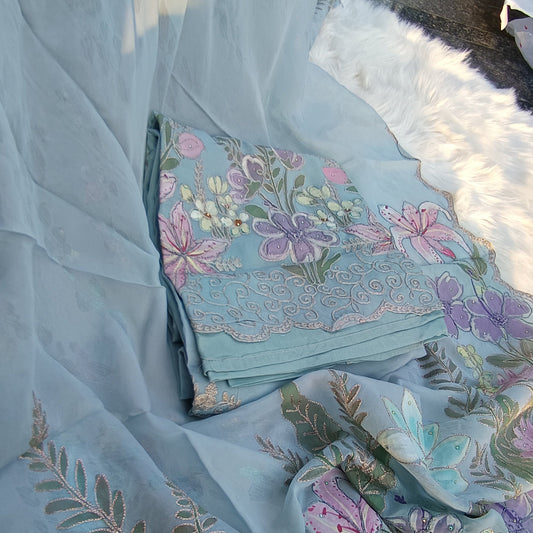 Elegant unstitched dress material with intricate floral embroidery for a personalized, stylish outfit.