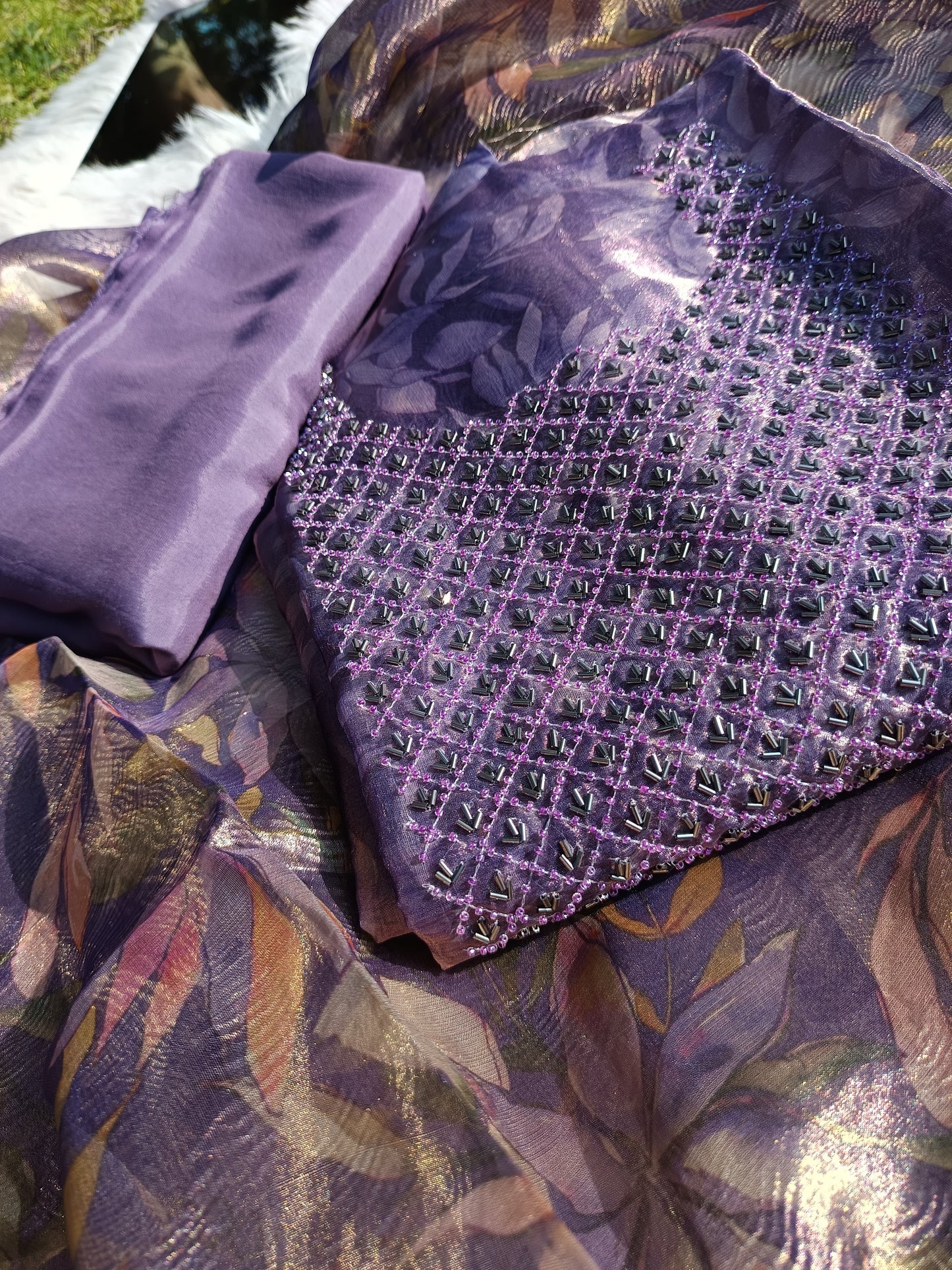 Full view of a hand embroidered tissue silk suit set with rich texture