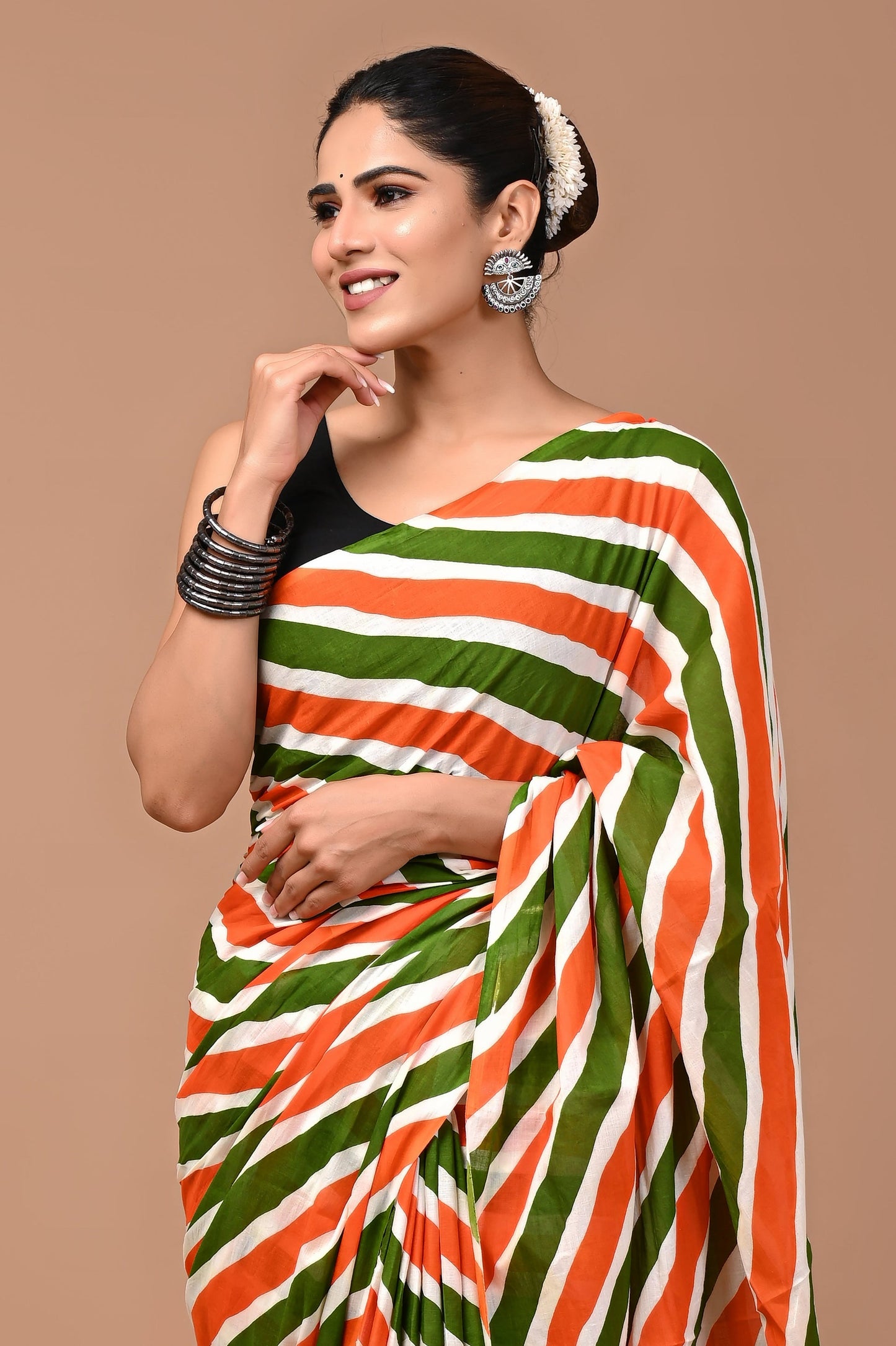 Soft and airy pure cotton mulmul saree with intricate prints, paired with a stylish blouse for elegance.