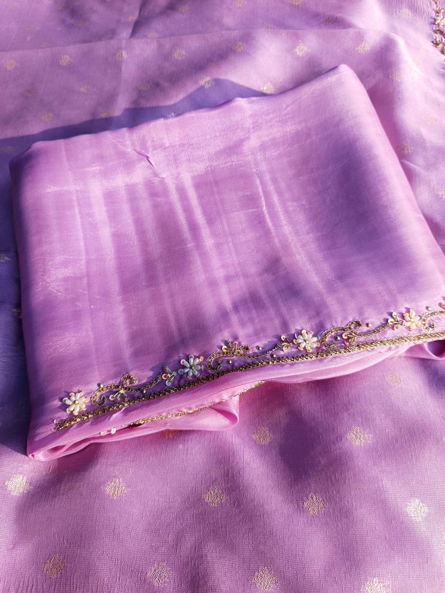 Display of pure tissue silk handwork suit on mannequin highlighting luxurious fabric.