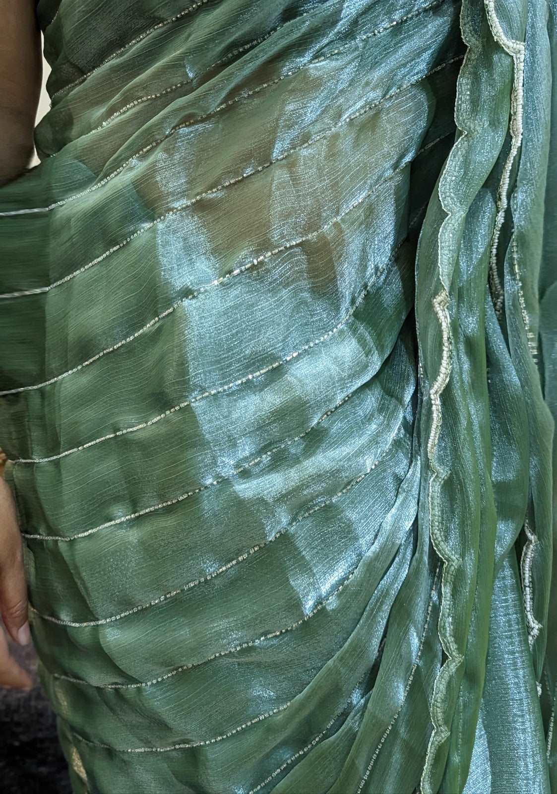 Stunning Persian Green Organza Saree with intricate Cutdana embellishments.