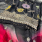 Richly draped Banarasi georgette suit in black with traditional golden patterns.
