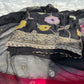 Close-up of fine georgette fabric and detailed weaving in a black Banarasi suit.