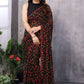 Stylish black and red Georgette saree with intricate prints, paired with an unstitched blouse.