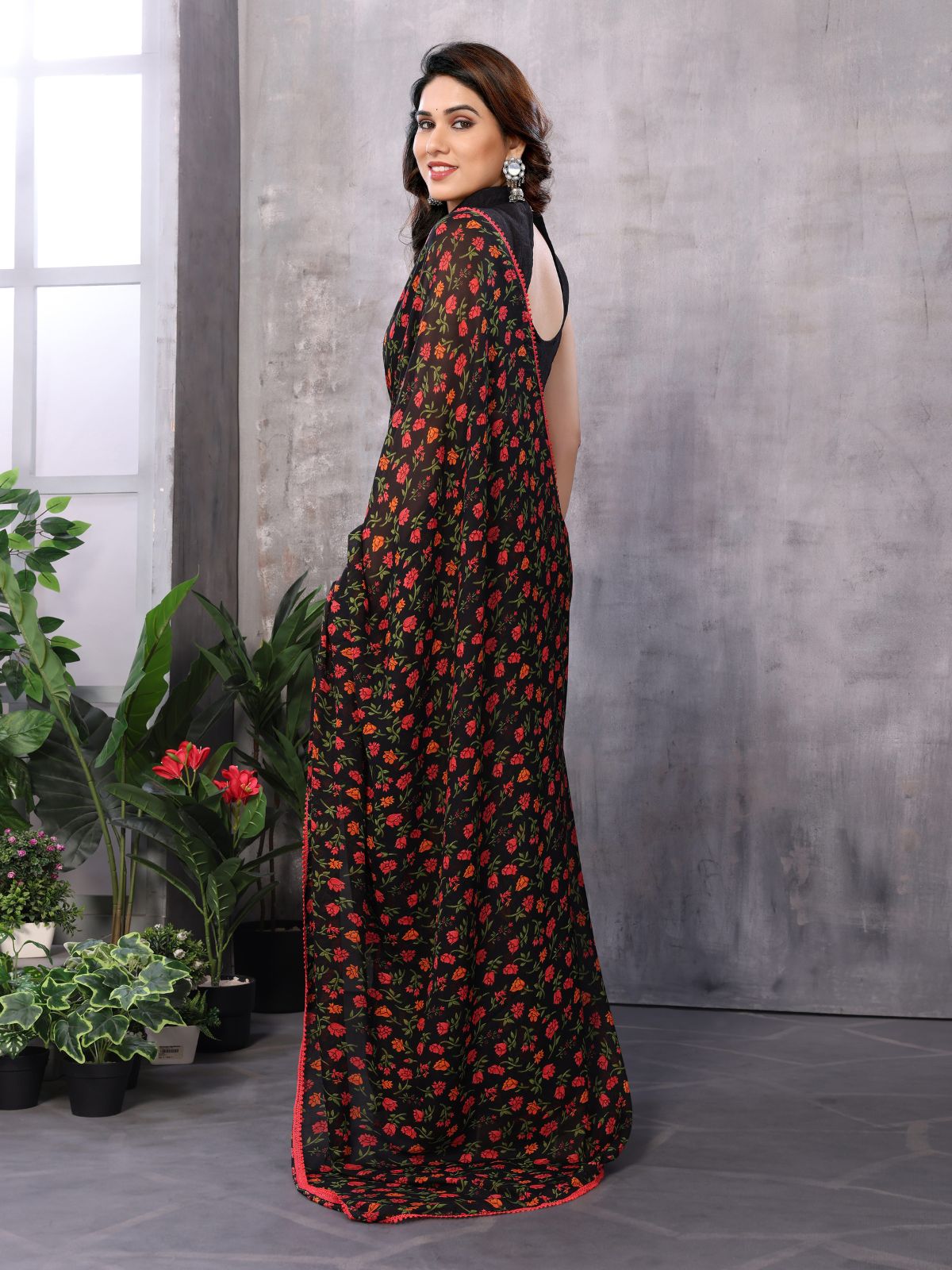 Sophisticated black and red saree in Georgette, complete with an unstitched blouse for customization.