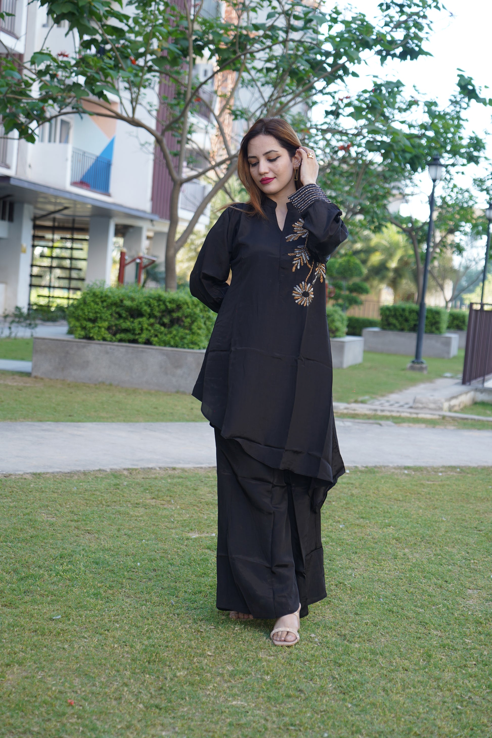 Chic V-neck tunic with intricate handwork and trousers.