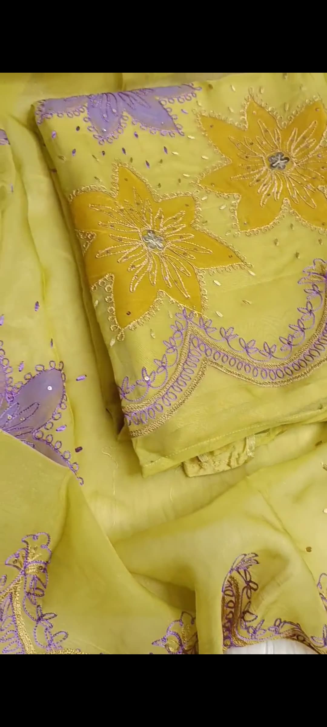Close-up of delicate threadwork on premium organza fabric with detailed hand embroidery