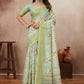 Woman wearing pastel green floral saree with blouse