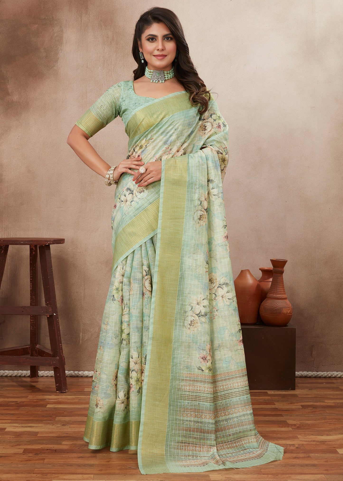 Woman wearing pastel green floral saree with blouse