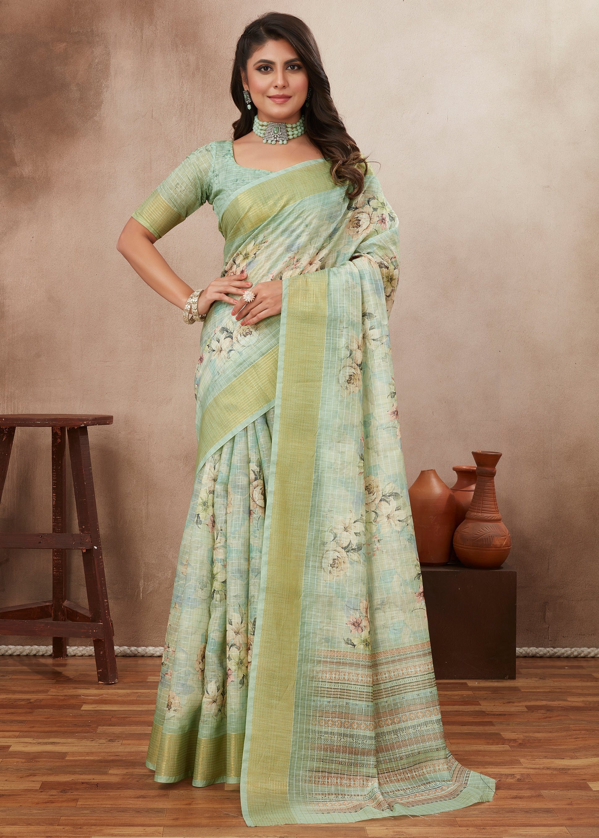 Woman wearing pastel green floral saree with blouse