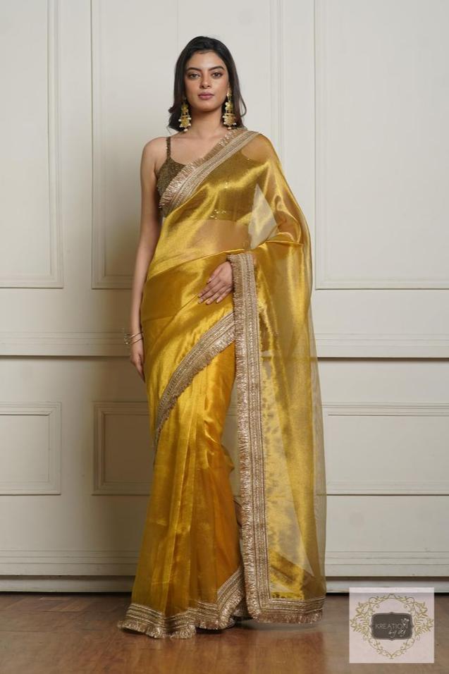 Golden Silk Saree - A luxurious silk saree with a shimmering golden finish, perfect for weddings and festive occasions.