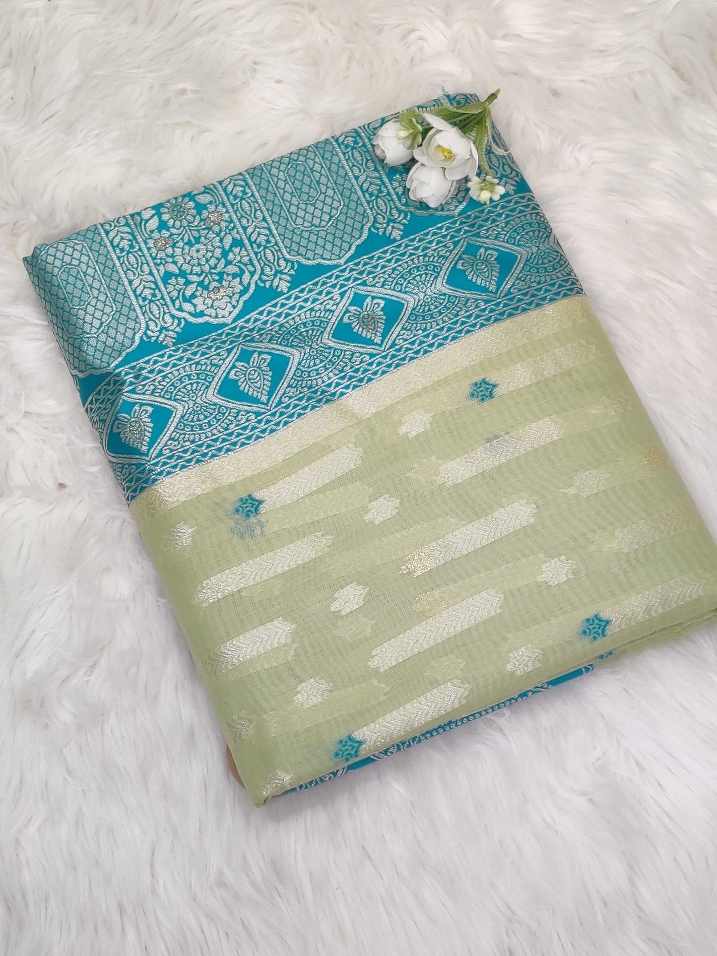 Green and blue-toned Organza Banarasi Saree featuring an intricate woven design, a signature piece by RedRuby Fashion for elegant occasions.