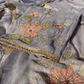 Side angle of grey organza suit highlighting its flowing silhouette and soft texture