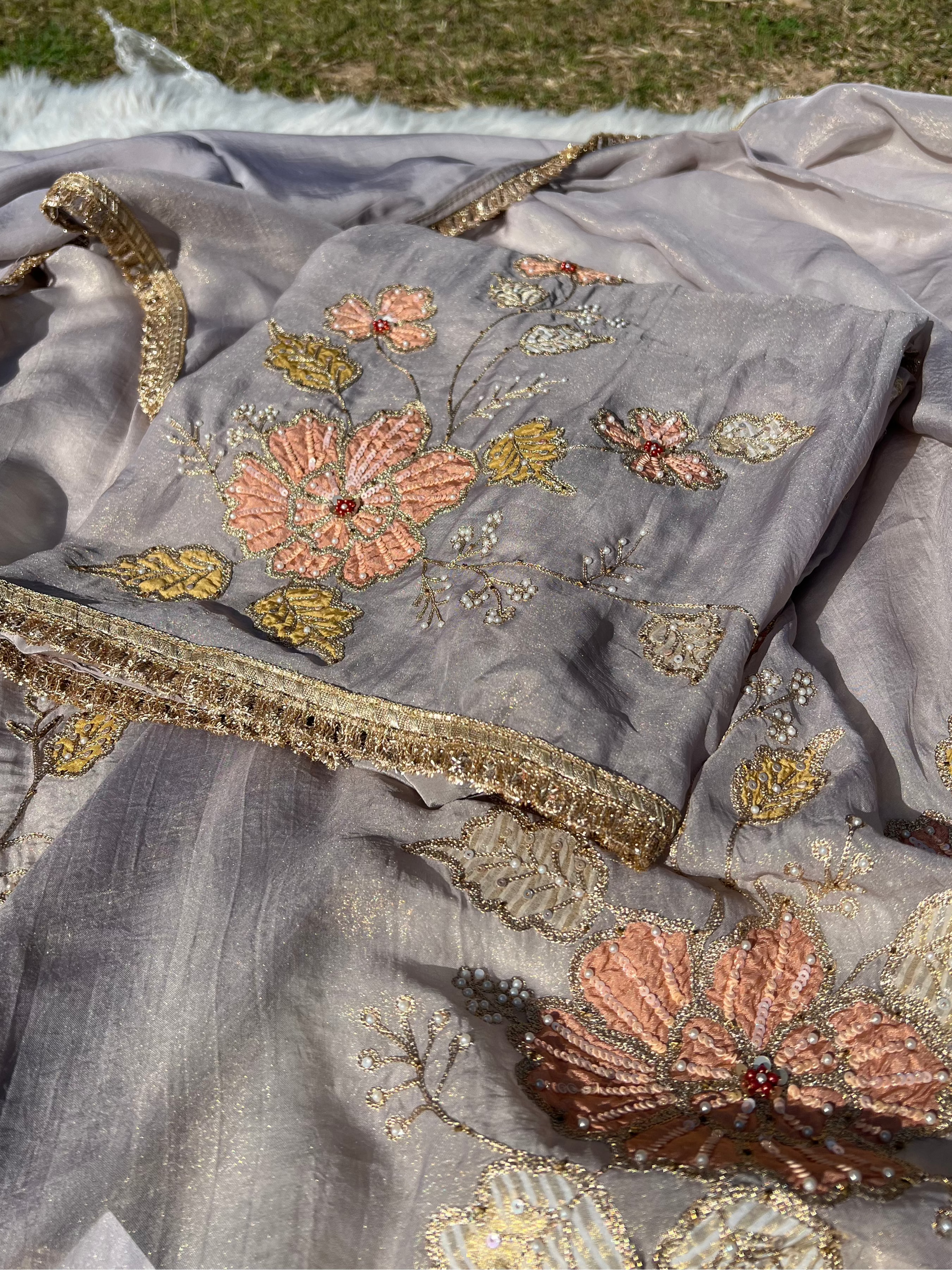 Side angle of grey organza suit highlighting its flowing silhouette and soft texture