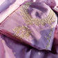 Close-up of intricate hand embroidery on pure tissue silk suit for women.