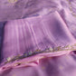 Zoomed-in shot of delicate handcrafted embroidery work on tissue silk fabric.