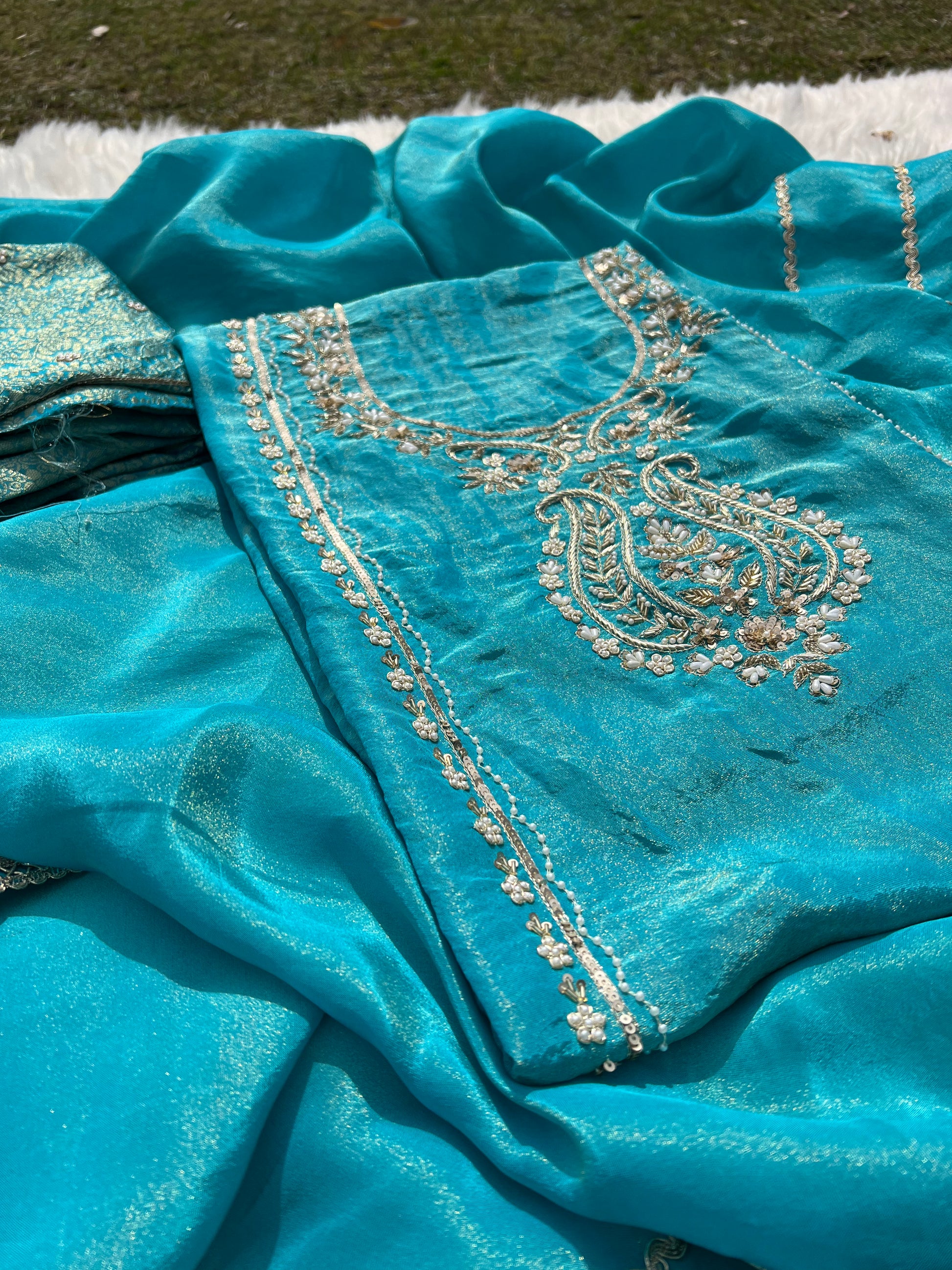 Soft ivory organza suit enhanced with luminous shimmer and hand-done embellishments