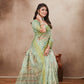 Model in mint green saree with floral patterns and matching blouse