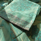 Close-up of the Parsi Serosky suit fabric highlighting delicate handwork and serosky embellishments