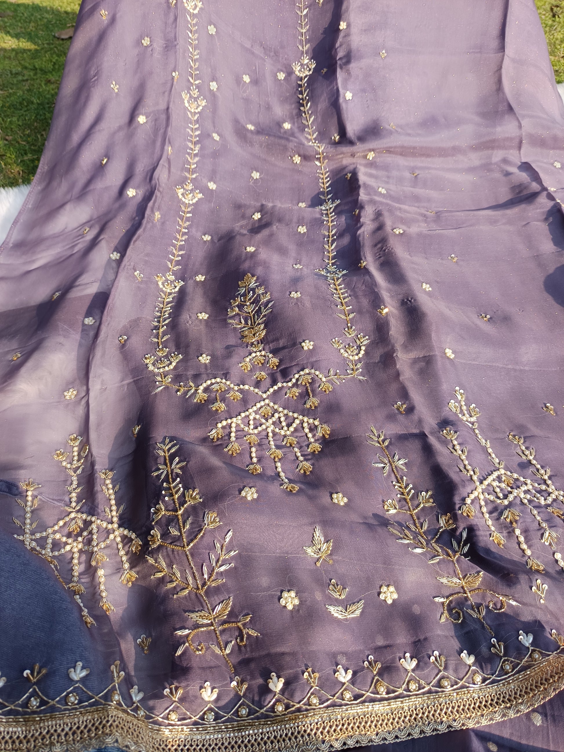 Zoomed-in view of the Shimmer Organza Suit’s hand-embellished sleeve craftsmanship.