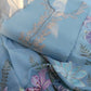 Beautiful unstitched dress material featuring delicate floral embroidery, ideal for crafting custom attire.